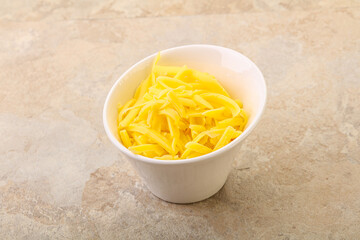 Shredded yellow cheese in the bowl