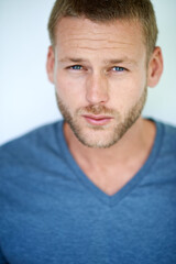 Playin it cool. Studio shot of a handsome young man posing against a white background.