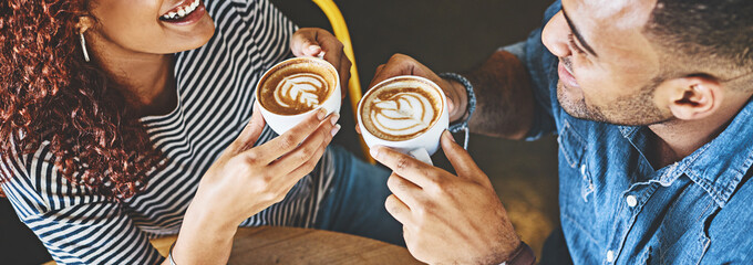 It all started with a coffee date. Cropped shot of a happy young couple sitting together in a cafe and enjoy a coffee during a date.