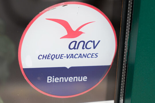 cheque vacances label signage ancv logo brand and text sign sticker on facade entrance door tourism hotel restaurant