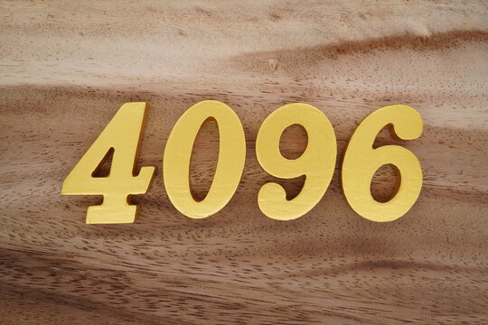 Golden Arabic numerals on a real brown and white wooden floor number 4096