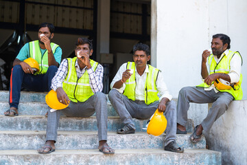 Group of Industrial workers having tea or coffee during break - concept of relaxation, coworkers...