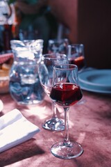 Table in restaurant with glass of aperitif in front