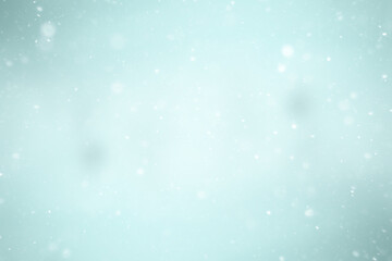 blurred snow / winter abstract background, snowflakes on abstract blurred glowing leaf background