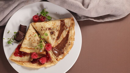 crepe with chocolate and raspberry jam