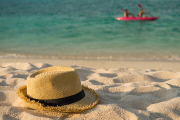 Hat on tropical island white sand beach. Travel summer holiday concept.