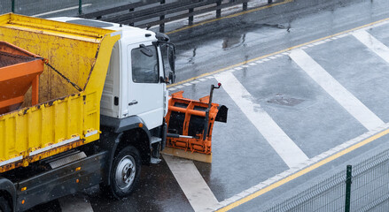 Naklejka premium Winter service vehicle clears snow covered roads