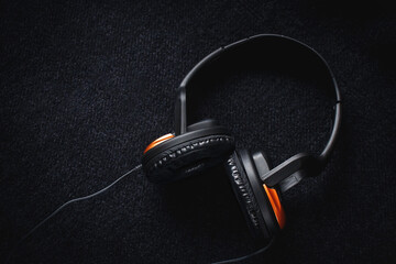 Headphones on a dark background with a place for the inscription