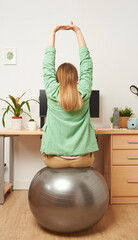 Woman stretching while working from home remotely