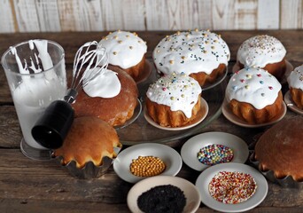 Pre holiday chores. Homemade Easter pastries with festive sprinkles for baking are displayed on a wooden background.