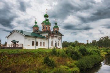 Fototapeta na wymiar Smolensky Cathedral of Olonets located on a small island Mariam, lying below the confluence of the rivers Olonka and Megregi in Karelia, Russia.