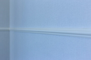White decorative plinth on a blue wall