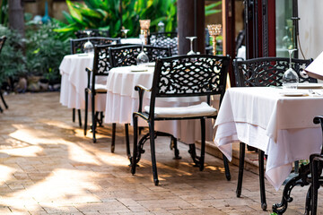 small street restaurant awaits visitors, outdoor tables set