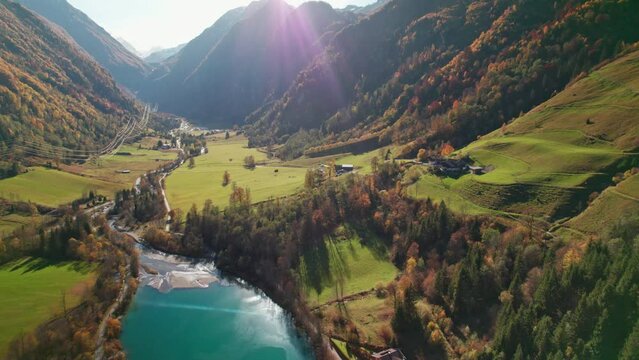 Drone Flight Over Klammsee Reservoir In Sunlit Autumn Valley
