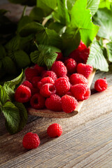 Fresh raspberries with leaves.