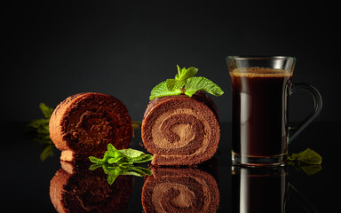 Chocolate cake with mint and a mug of black coffee.
