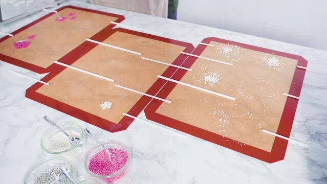 Making large homemade lollipops with different flavors.