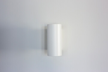 White wall lamp on a white wall