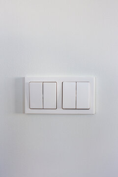 White light switches on a white wall