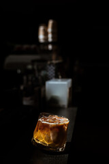 Ice coffee on a table with cream being poured into it showing the texture and refreshing look of the drink