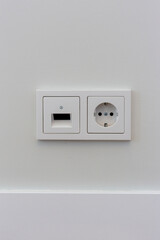 Double electrical socket on a white wall in the room