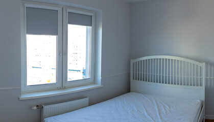 White bed in an empty bright room