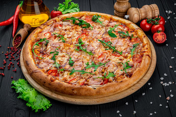 Delicious Italian pizza with sausage, ham and vegetables