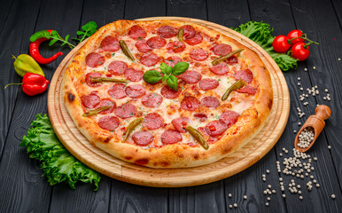 Delicious Italian pizza with sausage, ham and vegetables