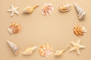 Fototapeta na wymiar Summer beach or sea concept. Frame from seashells, starfish on sand. View from above. Copy space.