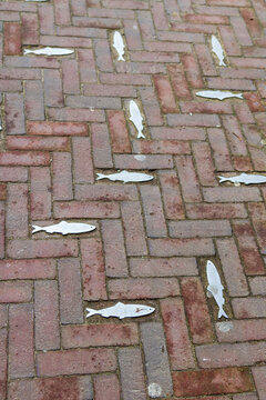 Metal fish between the bricks