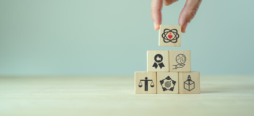 Core values,corporate values concept.  Company culture and strategy related to business and customer relationships, company growth. Principles guide company's action. Core values icon on wood blocks.