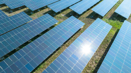 Aerial top view of solar panels or solar cells farm, renewable energy source. Ecotechnology for electric power in the industry.