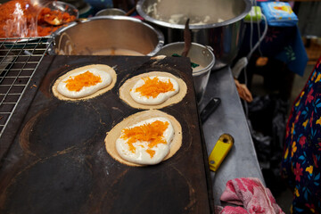 Thai crispy pancake on flying pan in street food
