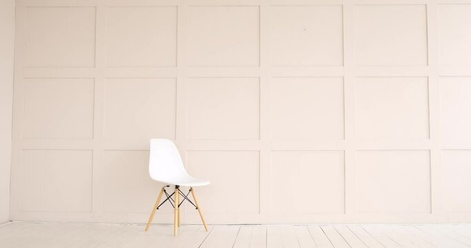 Modern empty chair against wooden wall
