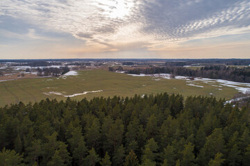 Spring sunset view over the fields and forest from a bird's eye view