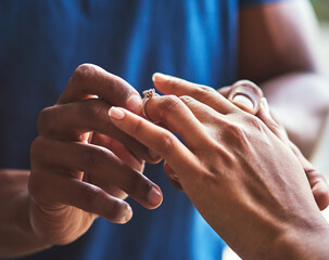 Its a celebration of eternal love. Closeup shot of an unrecognizable man putting an engagement ring onto his fiancees finger.