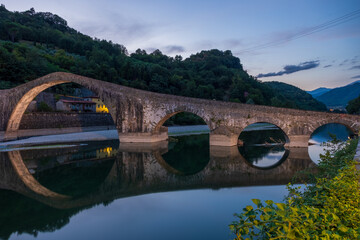 Devil's bridge during the Blue hour of a summer day, beautiful bridge in a tuscany valley in Lucca.