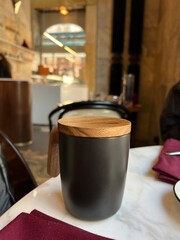 black cup with wooden lid