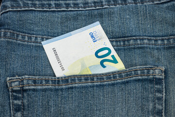Money in the pocket. Twenty euro note in the pocket of blue jeans
