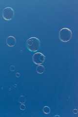 Natural Soap Bubbles Floating on Blue Background