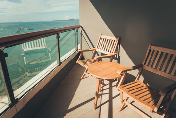Wooden chairs with beautiful sea view sunny day background in terrace room hotel. Travel summer beach holiday and hotel business concept.