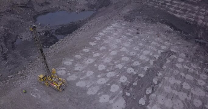 Aerial view of blasting holes coal mining area, open-pit mine, quarrying.  Drone shooting preparing for blasting open cast mine mining of coal, overall plan.