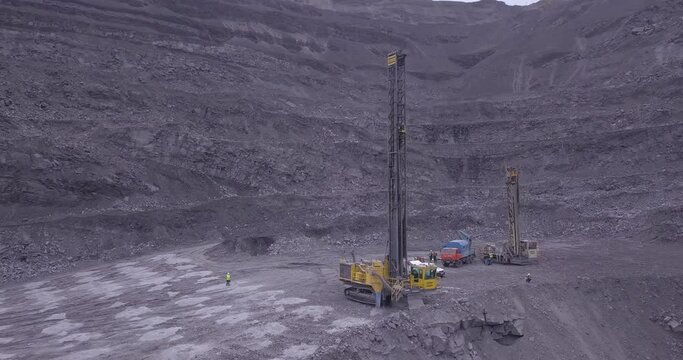 Aerial view of blasting holes coal mining area, open-pit mine, quarrying.  Drone shooting preparing for blasting open cast mine mining of coal, overall plan.