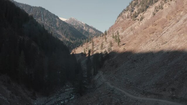 Aerial view of a road in the mountains with trees and river at Swat valley,Pakistan