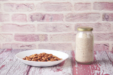 almond powder and almond in a jar on table,