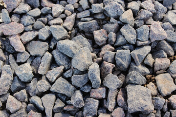 Natural Gray Granite Chippings, Macadam, Rubble or Crushed Stones Background Top View. Macro Photo of Broken Stone or Crushed Rock Texture