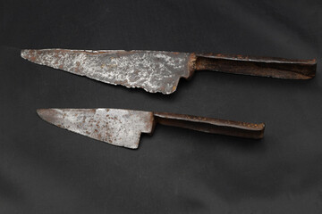 Antique rusty knife on black background