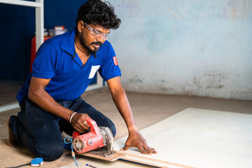 aluminium worker marking wood for design and renovation work at construction site - concept of...