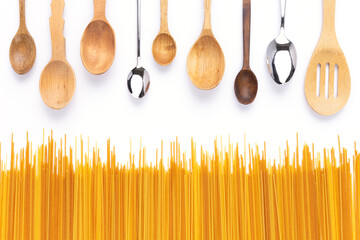 Raw pasta spaghetti and spoon at white background. Pasta food recipe