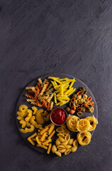 Pasta collection food at table background. Raw pasta assortment on slate stone